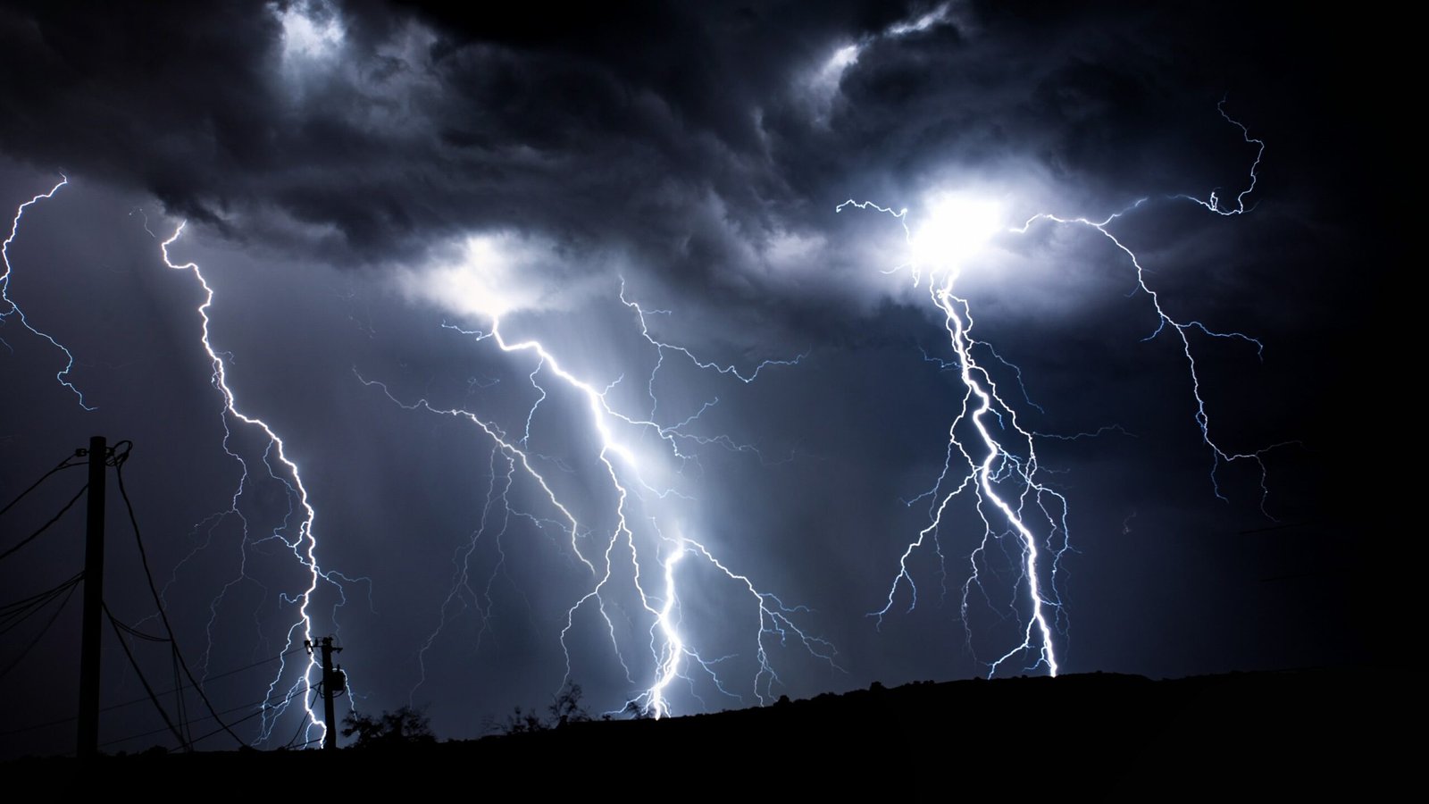 Multiple bolts of lightning strike across a dark, stormy sky. This image represents the intense energy and potential destructive power of uncontrolled anger.