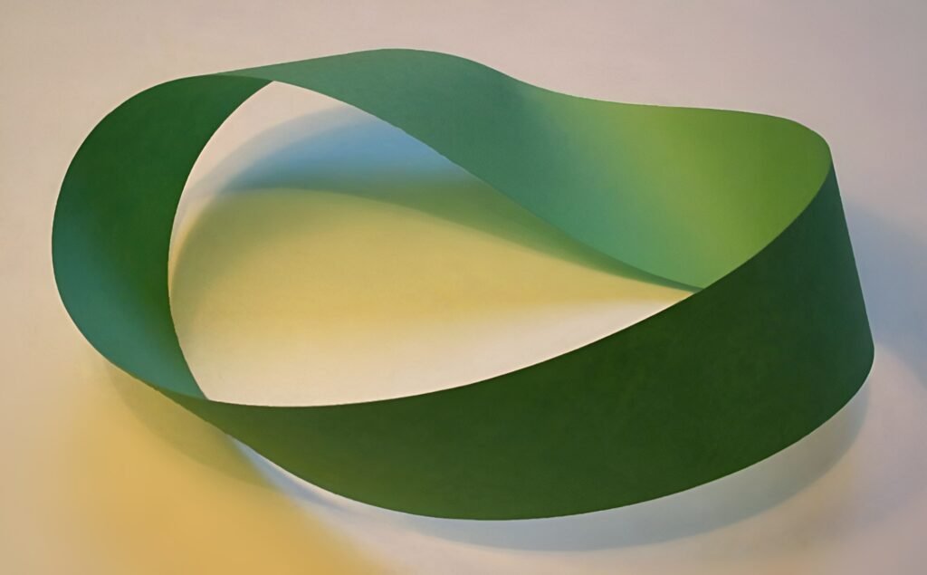 A 3D illustration of a Möbius strip, a continuous loop with a single surface, symbolizing endless cycles and interconnectedness.